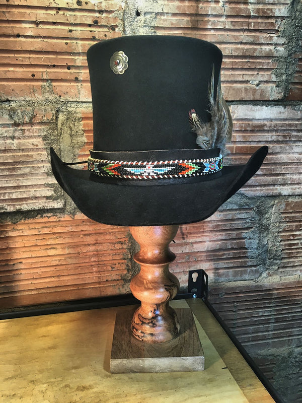 Just like the Phoenix rises from the ashes to be re-born, this 1950's beaded belt has been revived as a hat band. 