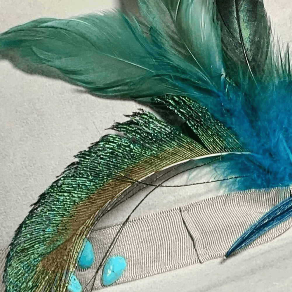 Close up of ribbon and feather detail on a custom hat